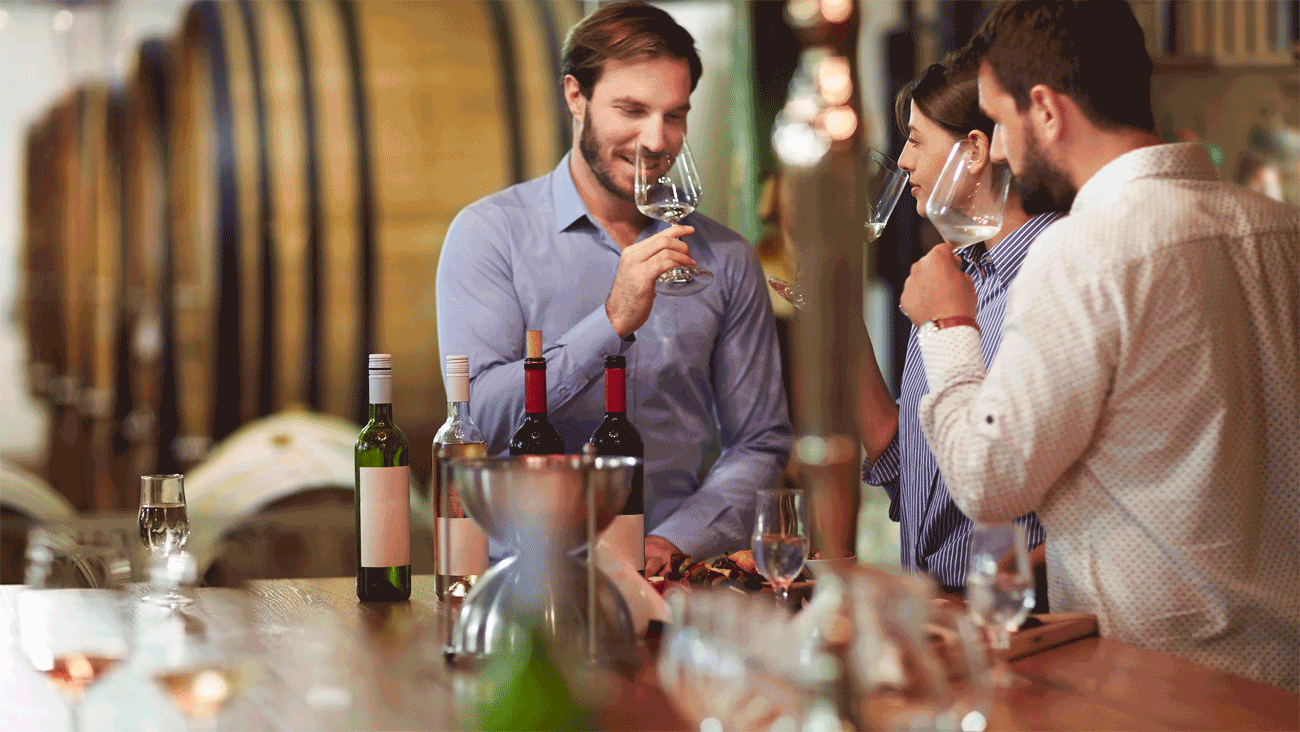Guests visiting a winery tasting room and enjoying a wine flight